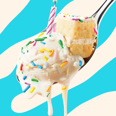 Pint of N!CK'S Birthday Cake light ice cream. The label highlights 'no added sugar' and '320 calories/pint'. A spoon holds a scoop of ice cream with sprinkles, a piece of cake, and a lit candle.