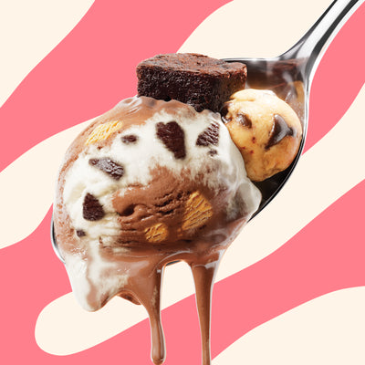 Pint of N!CK'S Brownie Cookie Dough light ice cream. The label highlights 'no added sugar' and '370 calories/pint'. A spoon holds a scoop of the ice cream, brownie, and cookie dough.