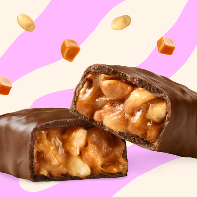 Packaging of Nick's Peanuts & Fudge chocolate bars with one bar partially unwrapped to display the product inside.