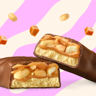 Box of N!CK'S Salty Peanut Protein Bars (12-pack), with an unwrapped bar cross-section displaying salty peanuts and caramel. Highlights 15g protein and "no added sugar."
