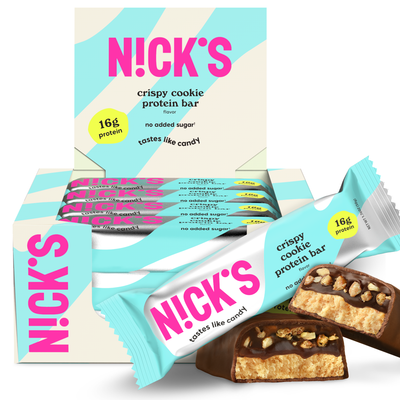 Box of N!CK'S Crispy Cookie Protein Bars (12-pack), with a bar unwrapped and cut to show the filling. Highlights 16g protein and "no added sugar" for a keto snack.